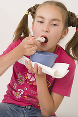 Image showing Girl eating porridge III