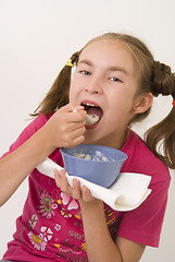Image showing Girl eating porridge IV