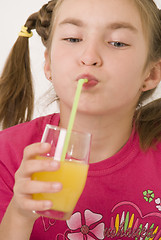 Image showing Girl drinking orange juice III