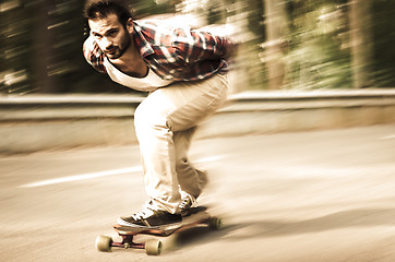 Image showing Downhill skateboarder in action