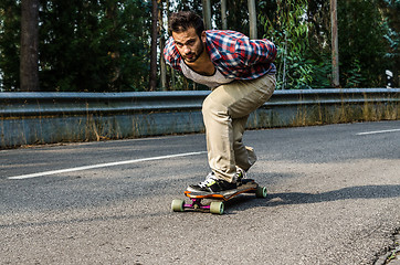 Image showing Downhill skateboarder in action