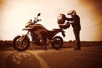 Image showing Biker on a misty sunset