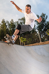 Image showing Skateboarder in a concrete pool 