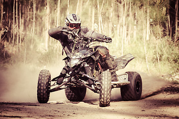 Image showing ATV racer takes a turn during a race. 