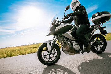 Image showing Biker in helmet road motorbike