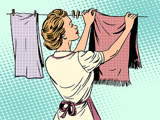 Image showing woman hangs clothes after washing housewife housework comfort