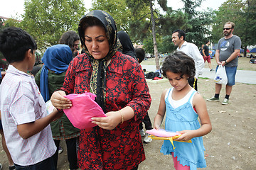 Image showing Woman and child receiving help