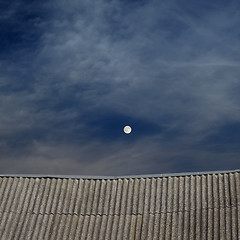 Image showing tiled top of the roof and cloudy blue sky