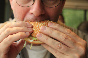 Image showing Man eating a hamburger