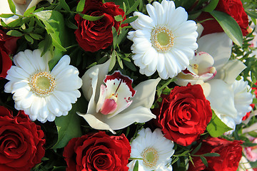 Image showing Cymbidium orchids, red roses and white gerberas