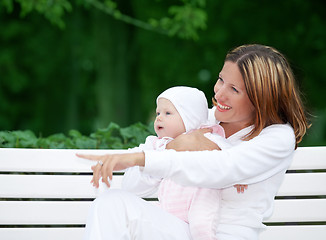 Image showing happy mother with baby on the bench