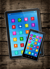 Image showing Smartphone and digital tablet PC with desktop icons on a dark wo