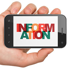 Image showing Information concept: Hand Holding Smartphone with Information on  display