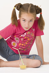 Image showing Girl drinking orange juice IV