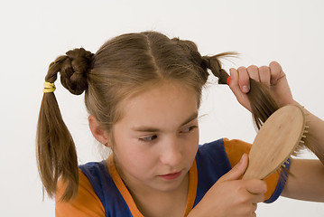 Image showing Brushing the hair gir