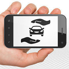 Image showing Insurance concept: Hand Holding Smartphone with Auto Insurance on display