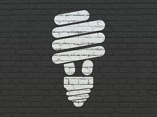 Image showing Finance concept: Energy Saving Lamp on wall background