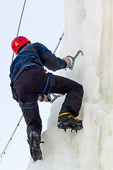 Image showing Man climbs upward on ice climbing competition