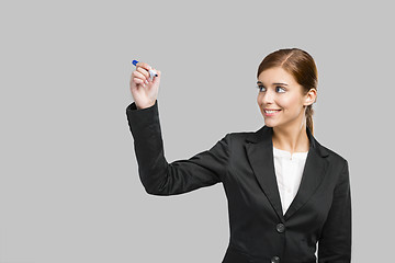 Image showing Businesswoman drawing on a glass board