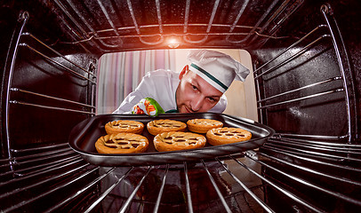 Image showing Chef cooking in the oven.