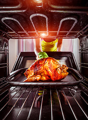 Image showing Cooking chicken in the oven at home.