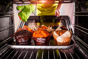 Image showing Baking muffins in the oven