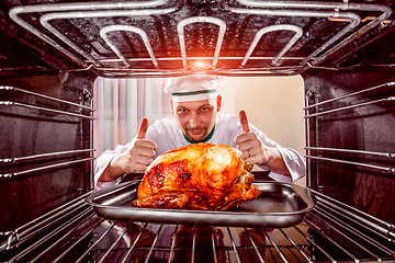 Image showing Cooking chicken in the oven.