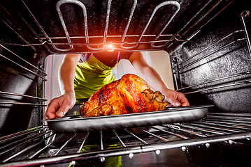 Image showing Cooking chicken in the oven at home.