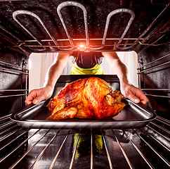 Image showing Cooking chicken in the oven at home.