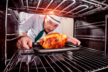 Image showing Cooking chicken in the oven.