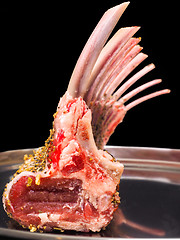 Image showing Rack of lamb seasoned on a silver plate