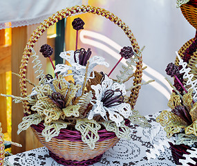 Image showing Original Souvenirs of woven straw are sold at the fair.