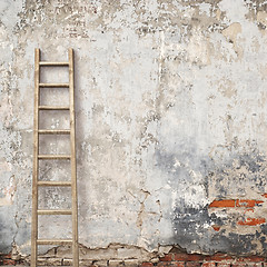 Image showing weathered stucco wall with wooden ladder