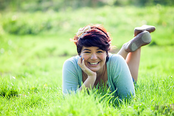 Image showing Teenage Girl Laying in Grass