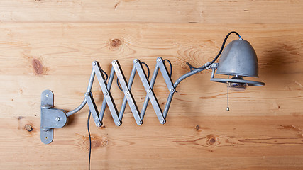 Image showing Old electric lamp, harmonica, on a wooden wall, Switzerland