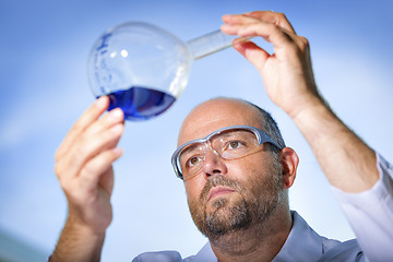 Image showing Chemist with blue liquid