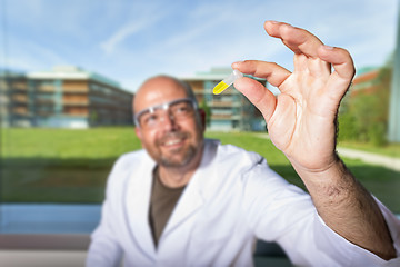 Image showing Chemist with yellow liquid