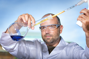 Image showing Chemist with blue liquid