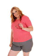 Image showing Young plus size woman standing in shorts.