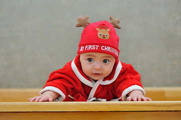 Image showing A baby in a Santa suit 