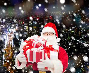 Image showing man in costume of santa claus with gift boxes