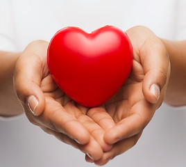 Image showing womans cupped hands showing red heart