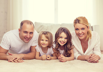 Image showing parents and two girls lying on floor at home