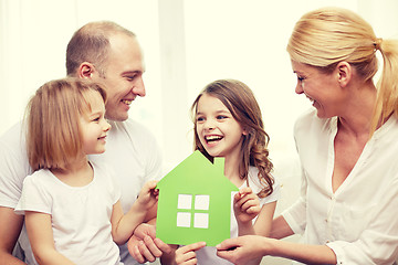 Image showing smiling parents and two little girls at new home