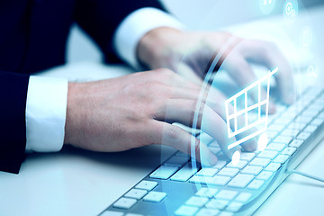 Image showing close up of hands with  keyboard and shopping cart