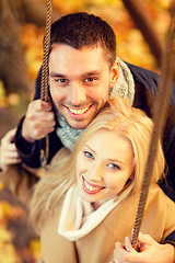 Image showing smiling couple hugging in autumn park