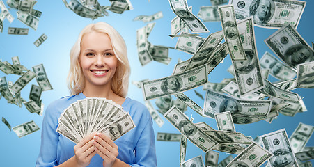 Image showing smiling businesswoman with dollar cash money