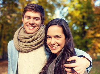 Image showing smiling couple hugging in autumn park