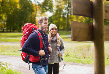 Image showing smiling couple with backpacks hiking