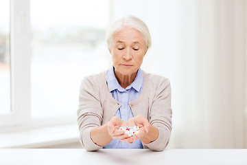 Image showing senior woman with medicine at home